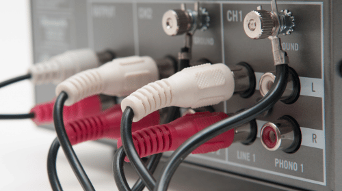 Image showing the back of a home audio system with speaker cable connected