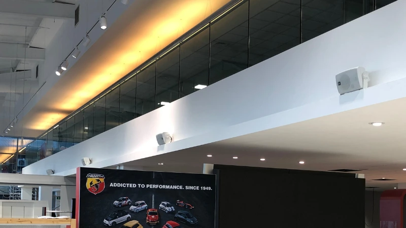 A Guide to 100 Volt Line Speaker Systems - Car Showroom with 100V line Speakers